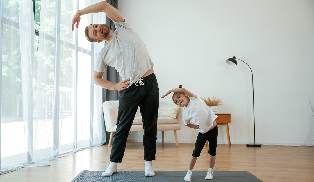 Spine,Exercise.,Father,With,Little,Daughter,Are,Doing,Yoga,At